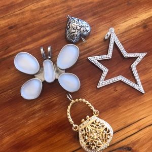 Four costume jewelry pendants.
